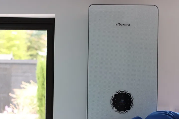 White wall-hung combi boiler mounted in a modern kitchen