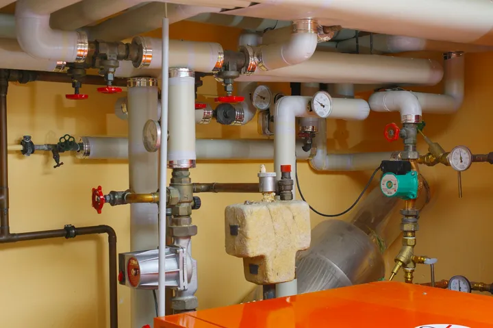 Pumps, gauges and pipework in a commercial plant room